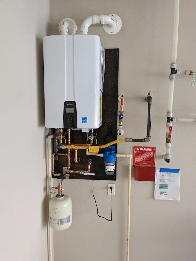 Professional plumber installing copper piping in a Clarkson home